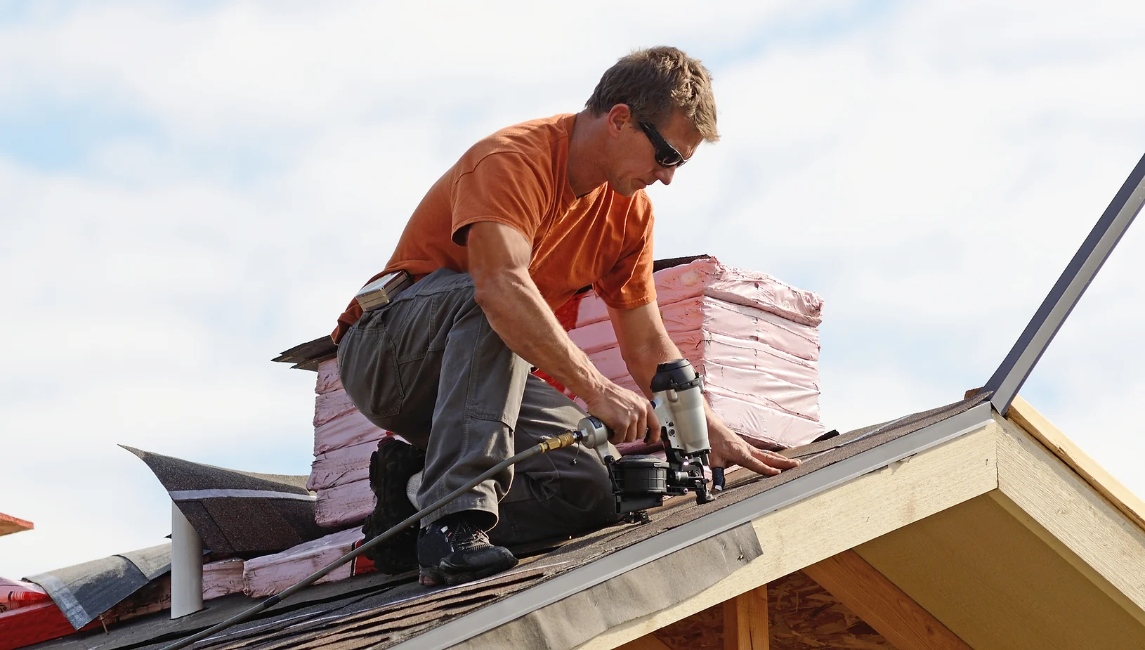 roofer-working-on-shingles-on-roof-of-home