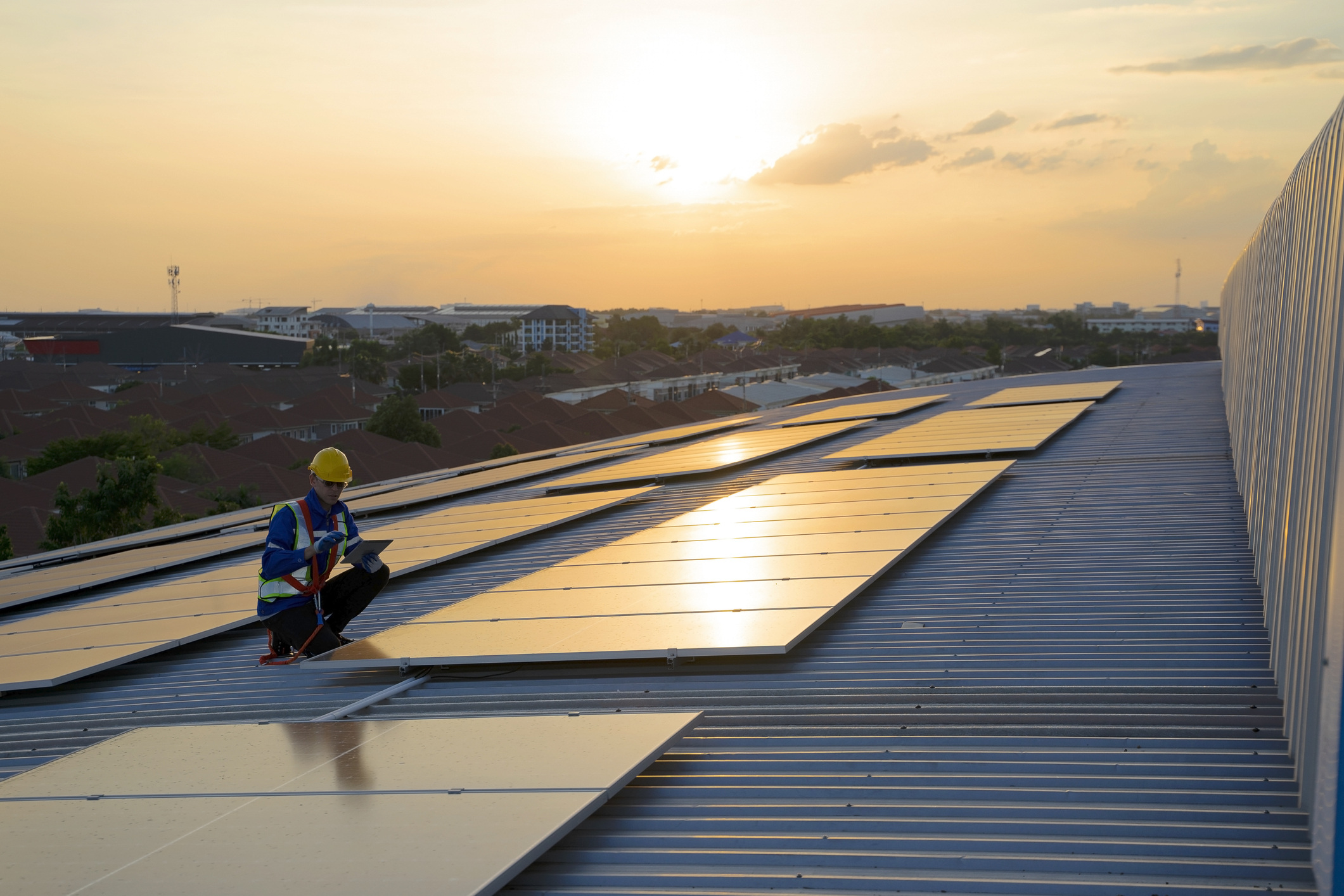 blue-collar-working-on-solar-panels-rooftop