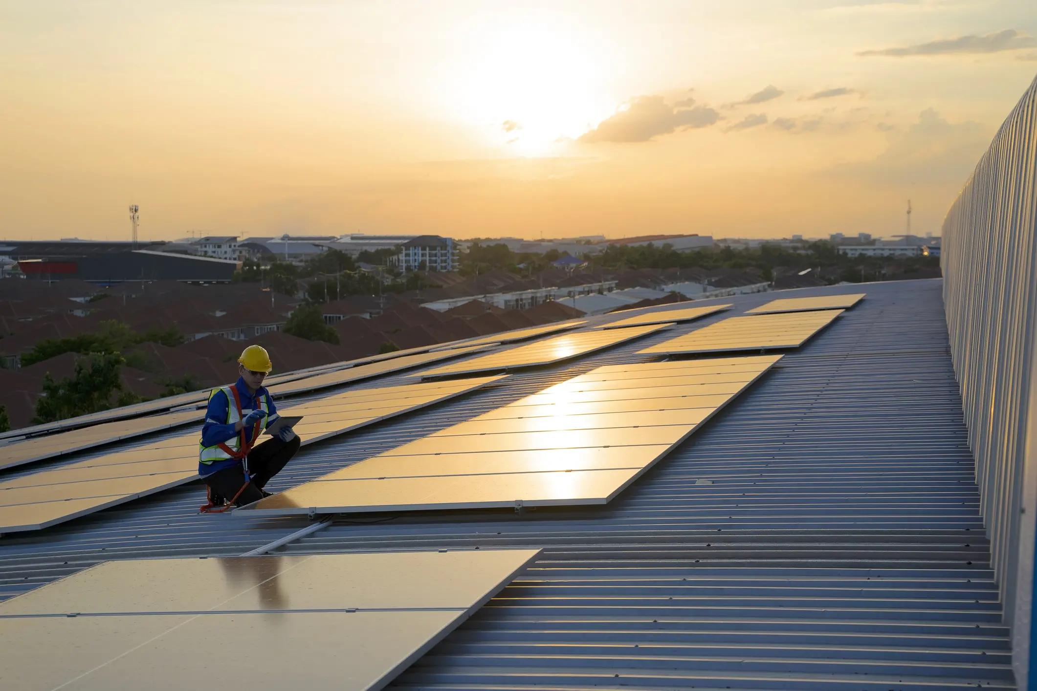 blue-collar-working-on-solar-panels-rooftop