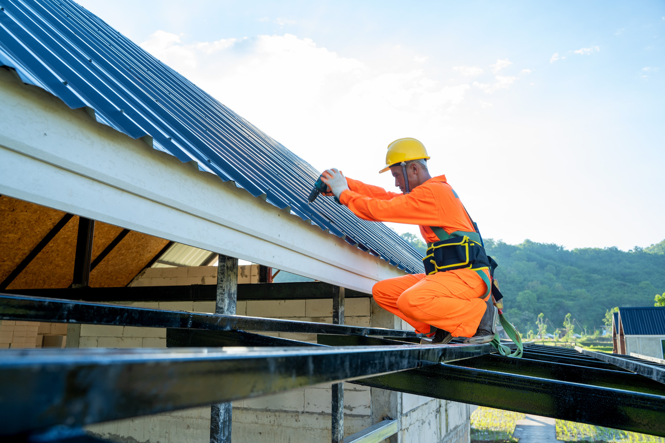 roofer-using-air-or-nail-gun-to-install-asphalt-shingle-on-new-roof