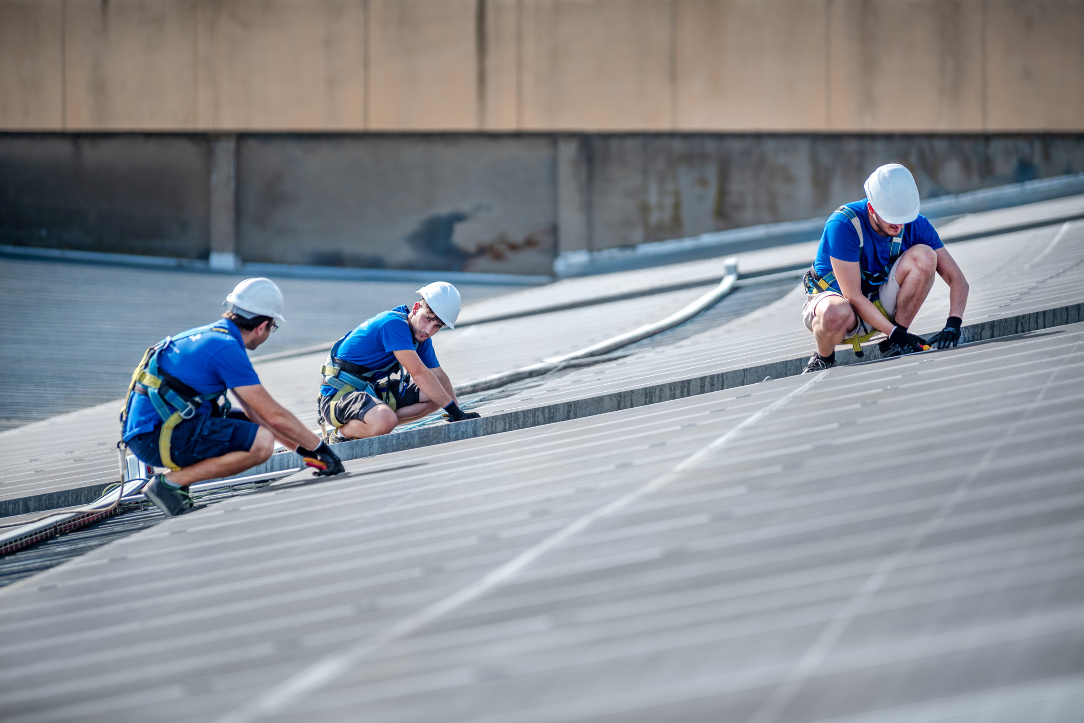 team-of-three-engineers-installing-solar-panels