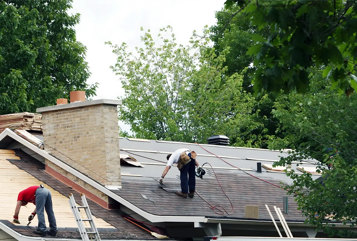 roofers working with impact resistant asphalt shingles